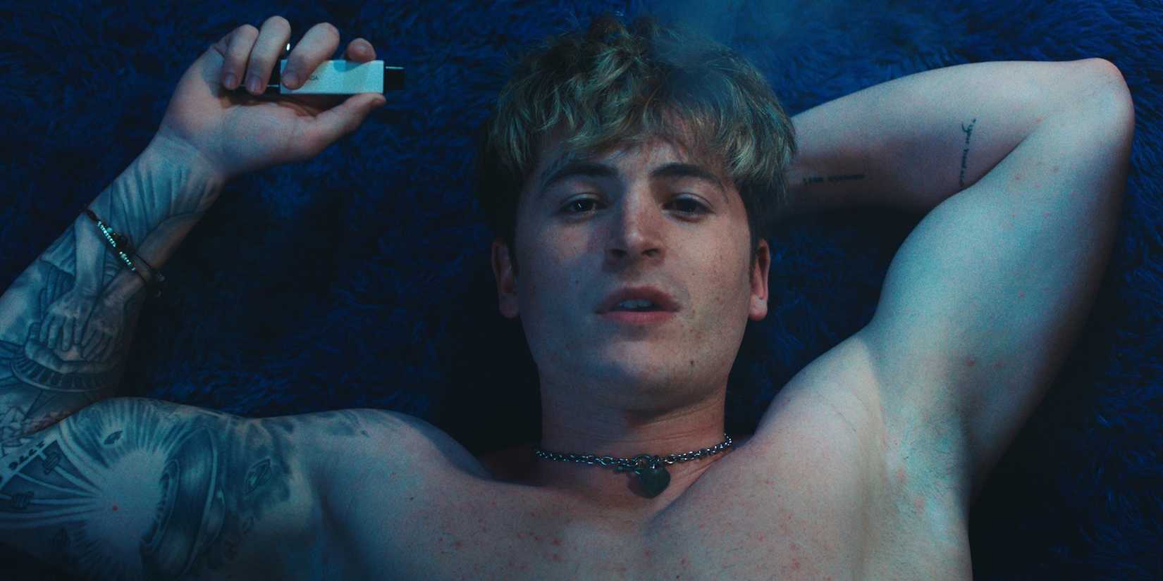 Kieron Moore lying on a bed in Blue Film