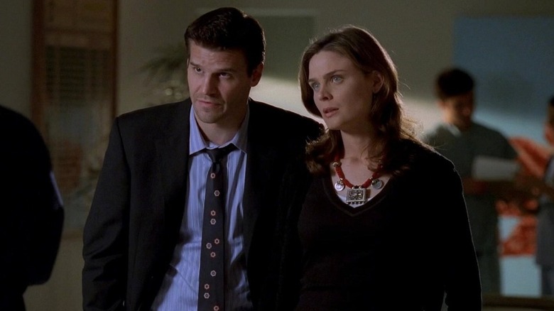 Booth and Brennan listening to someone speak