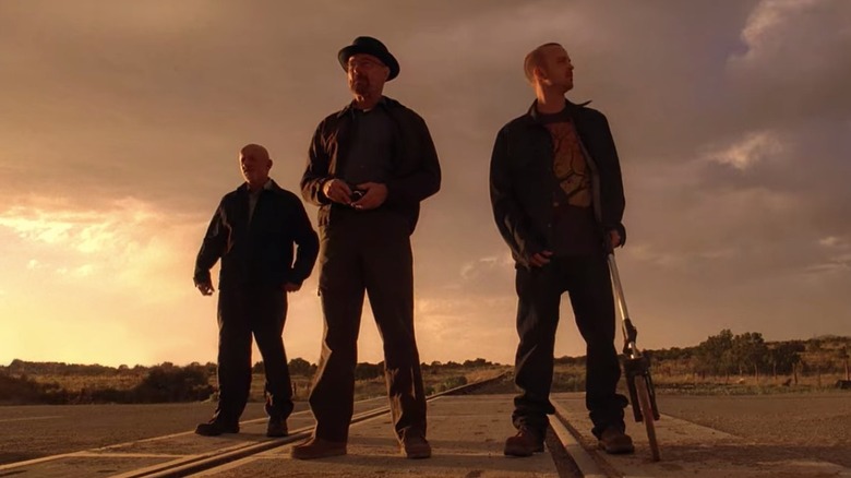 Jonathan Banks, Bryan Cranston, and Aaron Paul as Mike, Walt, and Jesse standing on train tracks in Breaking Bad