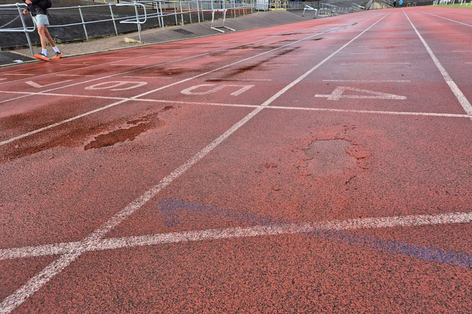 The track at Harvey Hadden Stadium, with numbered lane markings and areas of the track crumbling away.