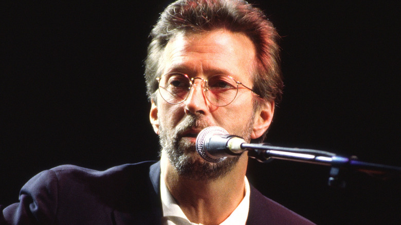 Eric Clapton singing into mic and looking away