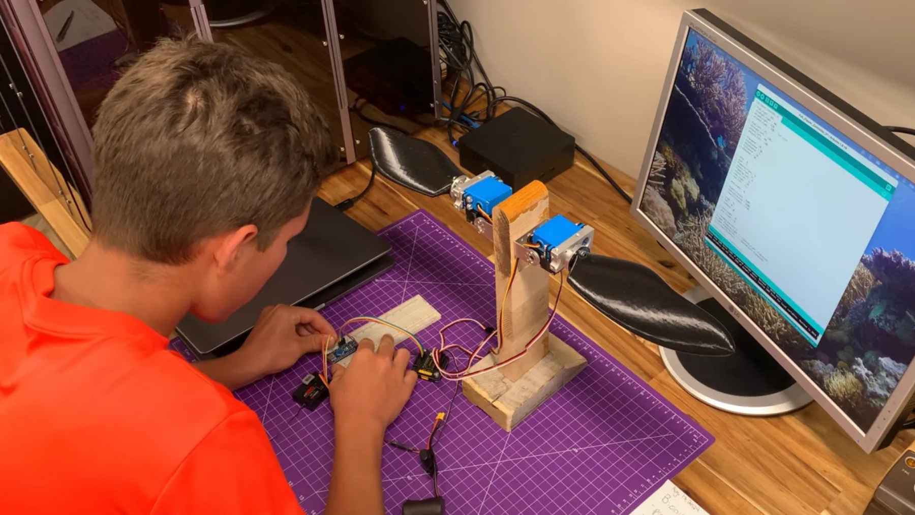 Ontario student Evan Budz works on the electronics and biomimetic flipper system used in the BURT robotic turtle project.
