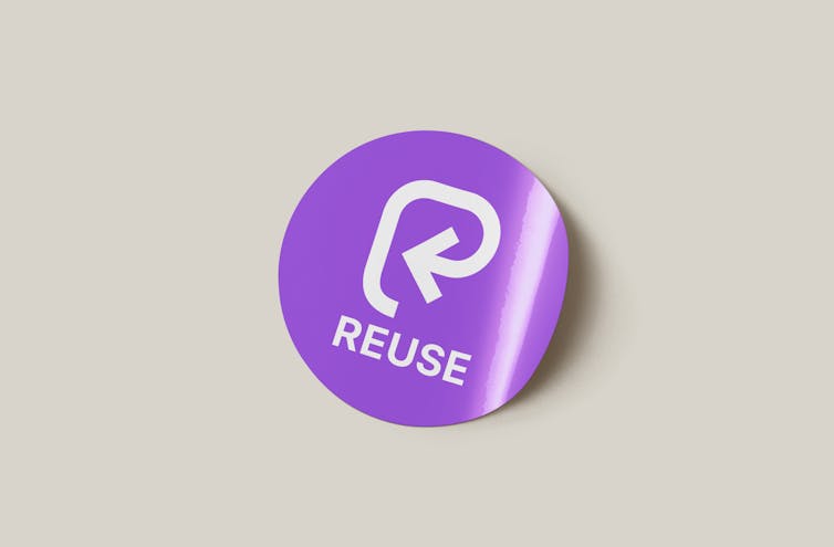 grey background, round purple sticker with reuse purple logo
