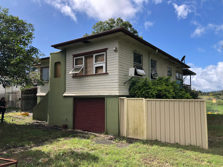 A weatherboard house that has suffered flood damage.
