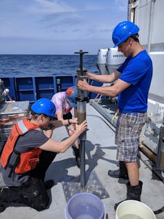 People on boat with sediment core