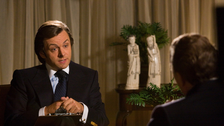 David Frost (Michael Sheen) speaks to Richard Nixon (Frank Langella) on a set in Frost/Nixon