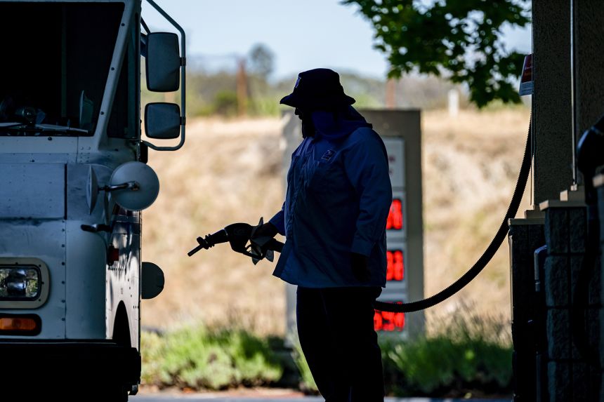 A driver refuels a vehicle with regular gasoline at a Shell gas station in Hercules, California, on May 21.