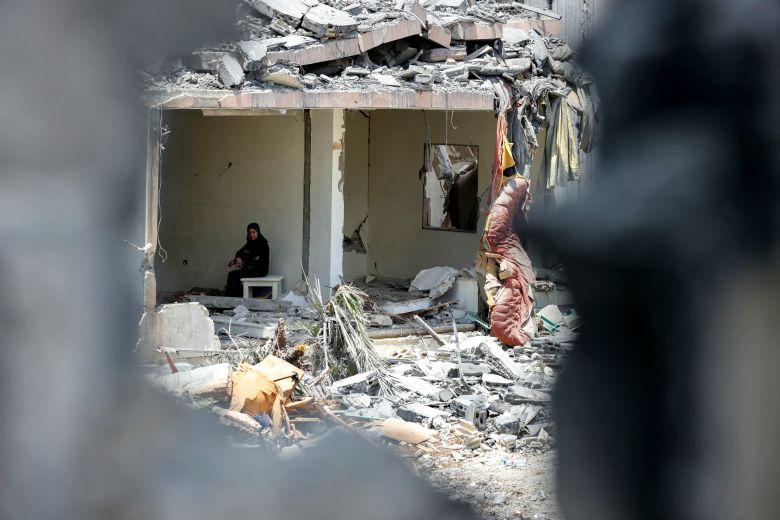A woman sits in the rubble of her destroyed home in the southern Lebanese village of Toul on June 18, 2026.