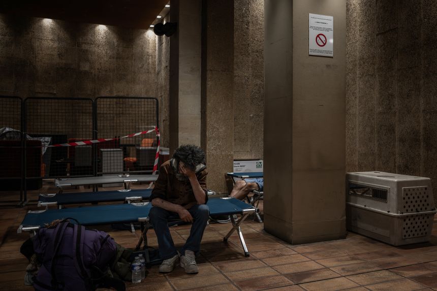 A man sits on a camp bed at an emergency heatwave relief centre opened by the city of Bordeaux as France experiences a heatwave, on June 22, 2026.