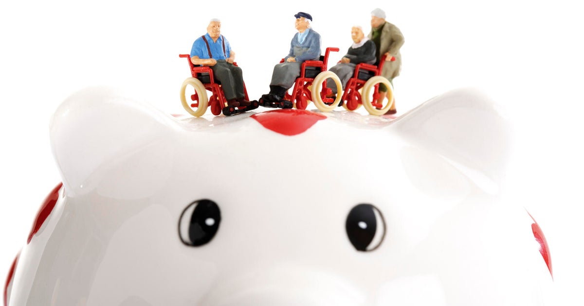 Figurine on wheelchairs on piggy bank
