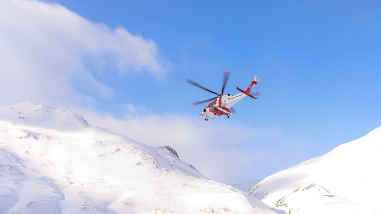 A helicopter performing a search and rescue operation over ice