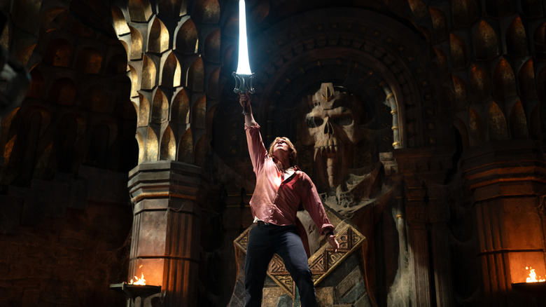 Prince Adam raising the Sword of Power inside castle Grayskull in Masters of the Universe