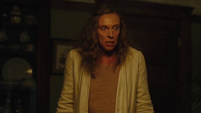 Toni Collette as Annie Graham in Hereditary, looking incensed off at someone out of the frame.