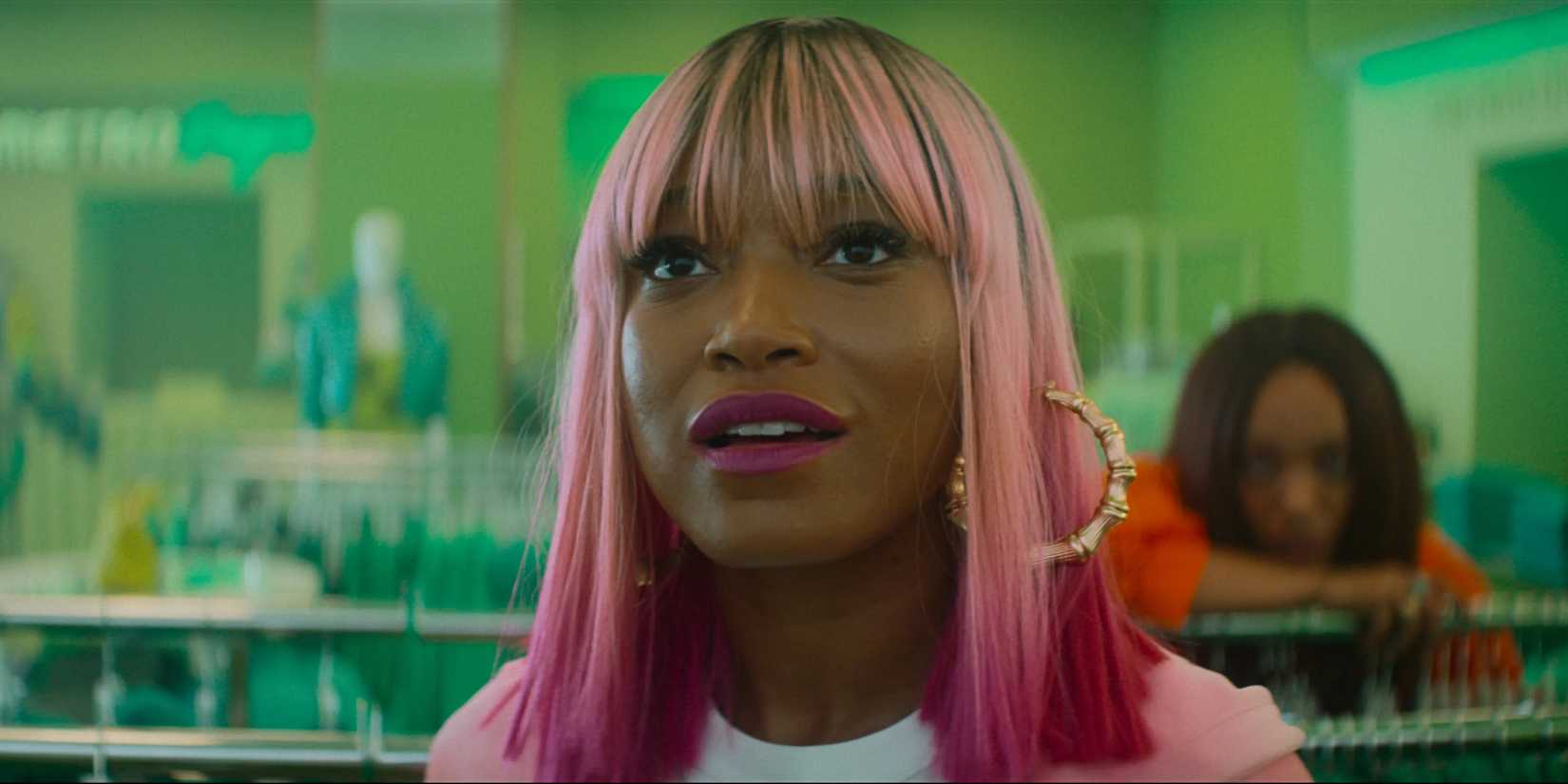 Keke Palmer staring up at a screen in a store in I Love Boosters