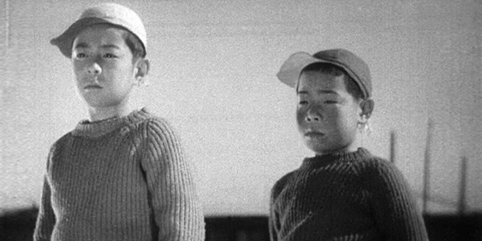 Two Japanese children looking intently off-camera in I Was Born, But... - 1932