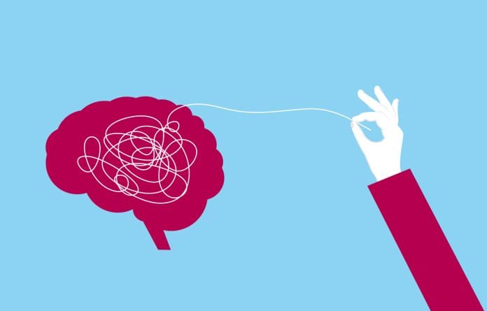 Hand pulling a thread from the brain to clear mental confusion and clarify thoughts