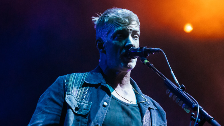 Josh Homme singing and playing guitar