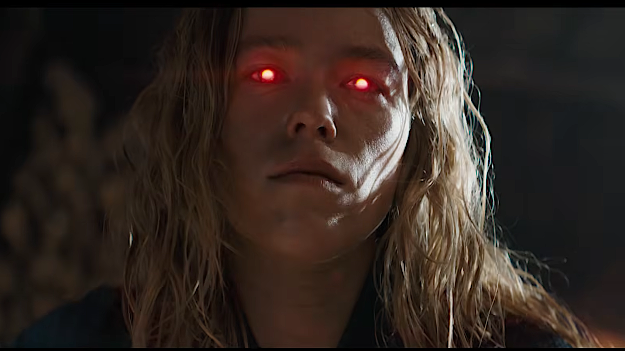 a blonde superhero girl with glowing red eyes