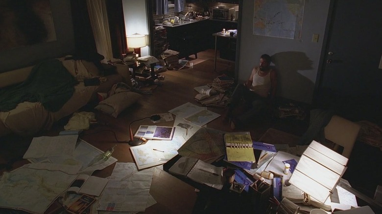 Jack surrounded by papers, looking disheveled on Lost