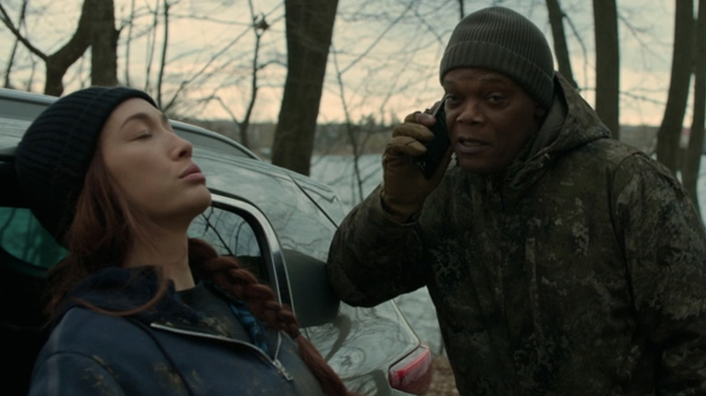 Maggie Q's Anna Dutton leans on a car as Samuel L. Jackson's Moody Dutton talks on a cellphone in The Protégé