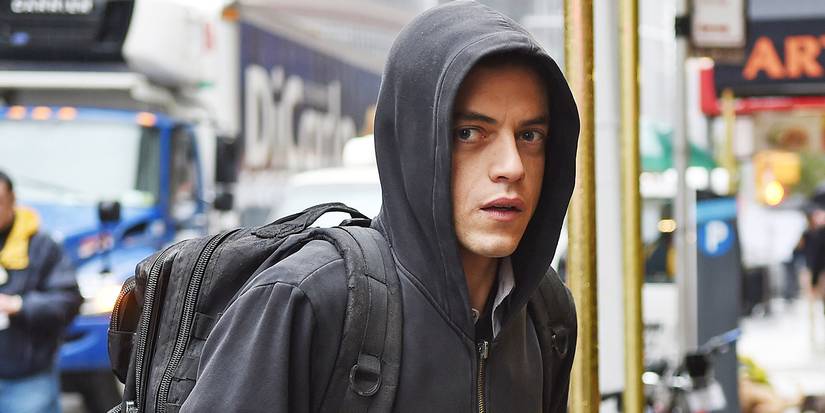 Rami Malek as Elliot Alderson walking wearing a hoodie in 'Mr. Robot'