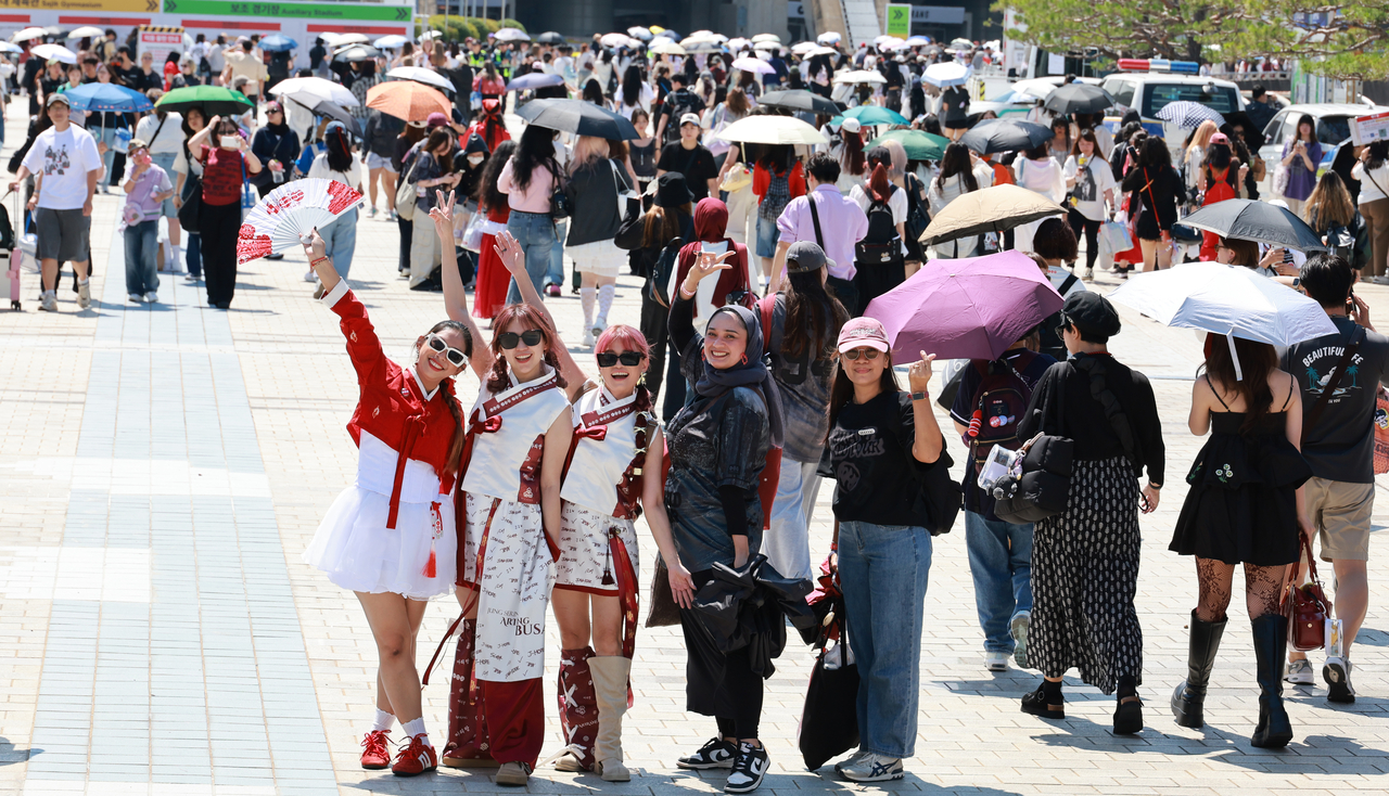 BTS fans pose for photos at Busan Asiad Main Stadium, where the Busan leg of BTS' "Arirang” tour took place on Friday and Saturday. (Yonhap)