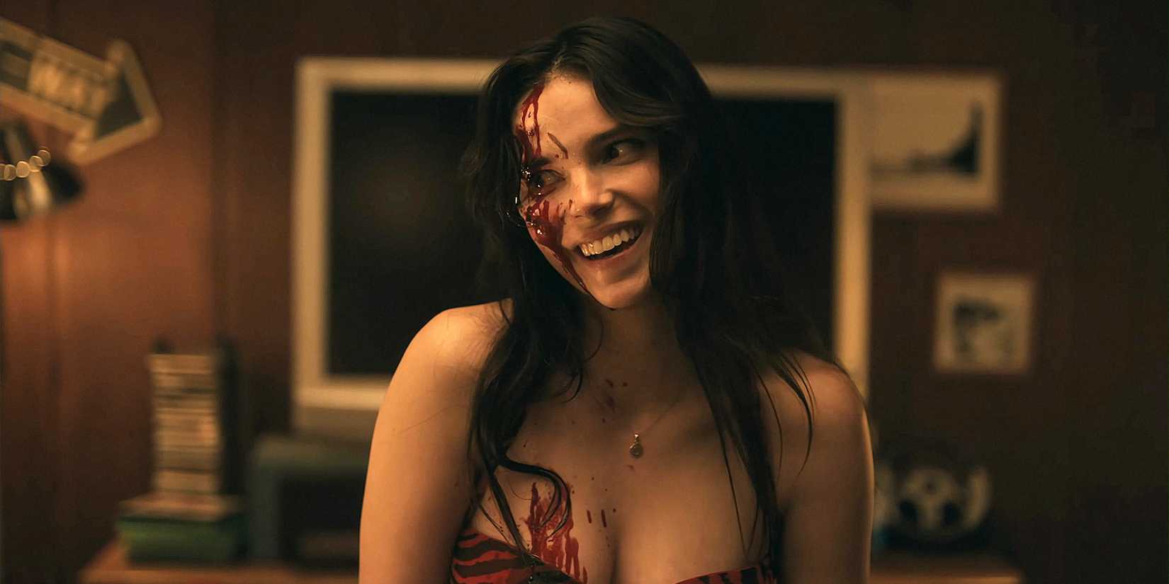 Nikki (Inde Navarrette) smiling with blood on her face and body in 'Obsession'