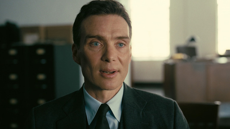J. Robert Oppenheimer (Cillian Murphy) speaks seated in an office in Oppenheimer