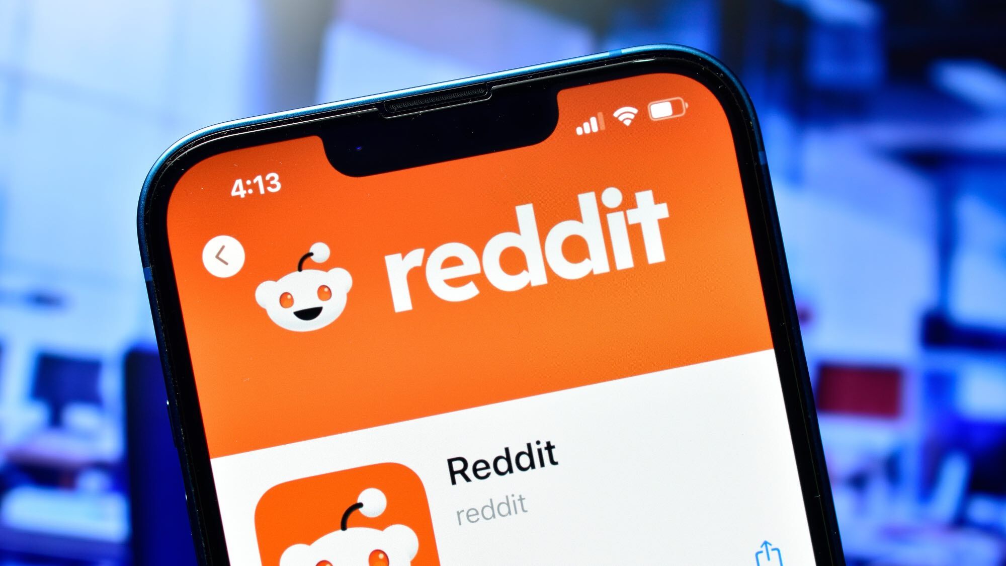 Reddit app logo on a phone, blue background