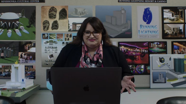 Reagan Wells smiling while looking at laptop