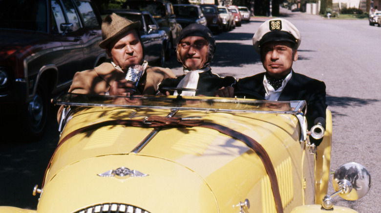 Dom, Marty, and Mel riding in a yellow car in Silent Movie (1976)