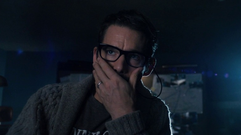 Ethan Hawke as Ellison Oswalt in Sinister, looking at something out of frame with his hand over his mouth.