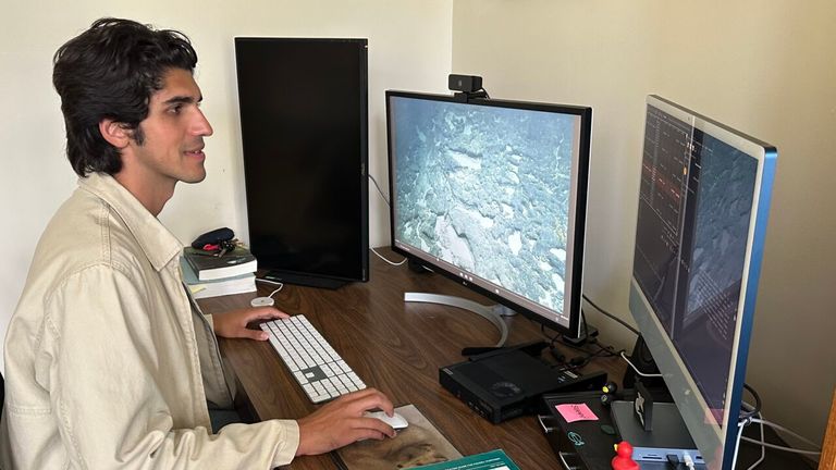 Aaron Judah combing through archive footage to confirm the goblin shark sighting. Pic: University of Hawai'i at Manoa