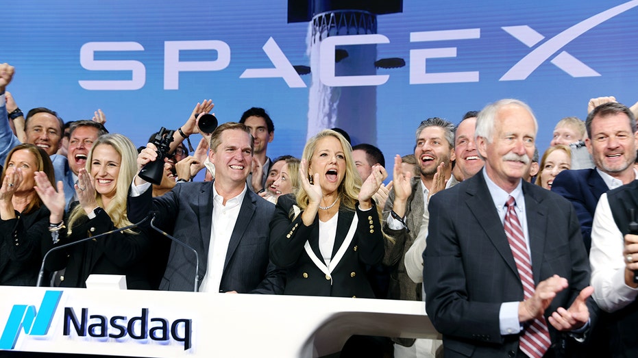 SpaceX executives ring the opening bell at the Nasdaq.