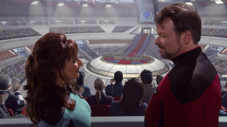 Marina Sirtis and Jonathan Frakes as Deanna Troi and William Riker in a grand hall in Star Trek: Enterprise
