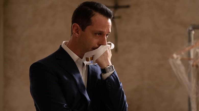 Kendall Roy (Jeremy Strong) tearfully holds a white ribbon in Succession