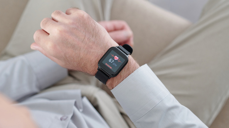A smartwatch tracking heart rate on someone's wrist