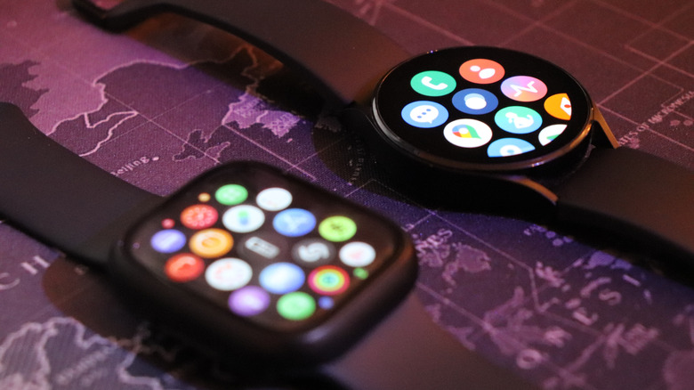 An Apple Watch Series 8 next to a Galaxy Watch 4.