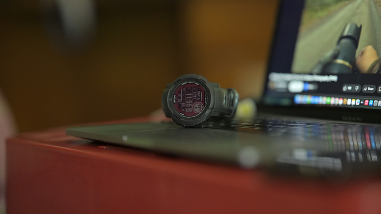 The Garmin Instinct 2 Solar placed on a MacBook.