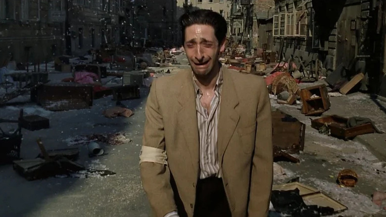 Władysław Szpilman (Adrien Brody) weeps as he walks through a wrecked Polish street in The Pianist (2002)