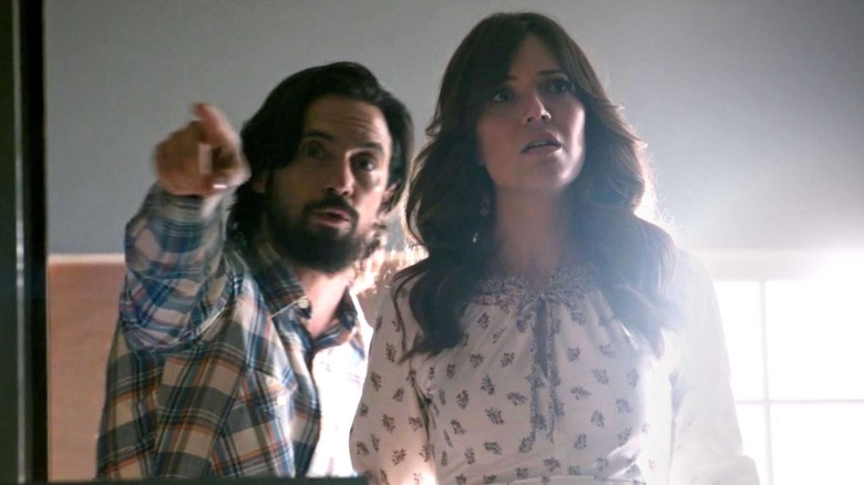 Milo Ventimiglia as Jack Pearson and Mandy Moore as Rebecca Pearson, stepping through a threshold together in This Is Us.