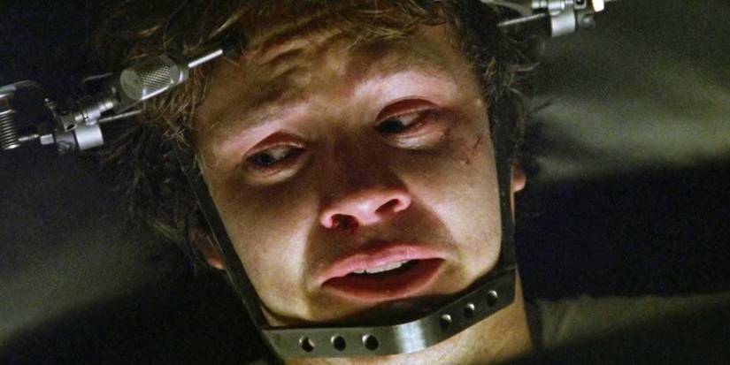 Tim Robbins looking terrified with a machine strapped to his head in Jacob's Ladder.