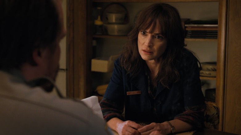 Winona Ryder as Joyce looking at David Harbour as Hopper in Stranger Things