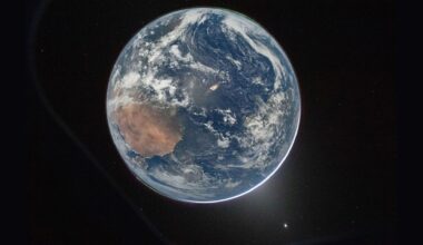 A view of Earth with a glow behind it.