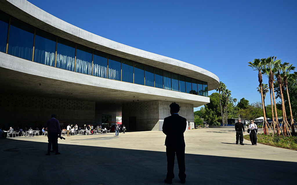 People walk around the curved architecture of the David Geffen Galleries at the Los Angeles County Museum of Art (LACMA) on April 15, 2026, in Los Angeles, California.