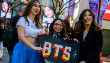 From left, Mexican content creators and BTS fans Fer Vega, Susy Mouriz and Nataly Pop pose for a photo in Myeong-dong, Jung District, Seoul, March 19, two days before the group