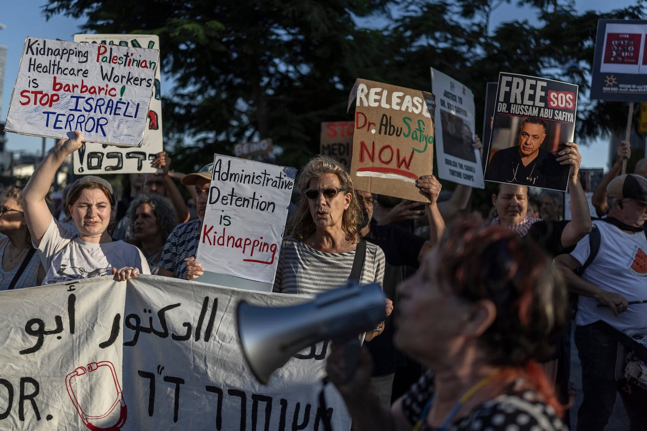 Activists hold up placards at a demonstration.