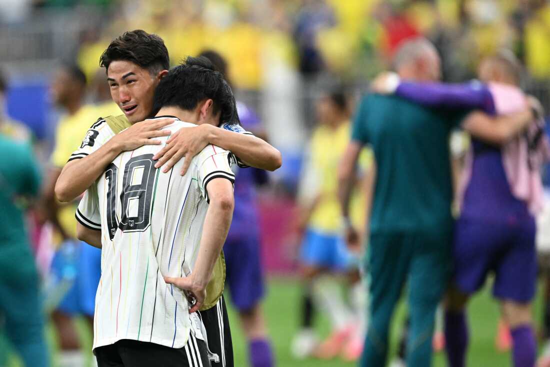 Teammates on Japan's national team react at the end of the World Cup match between Brazil and Japan in Houston on June 29. Brazil won 2-1.