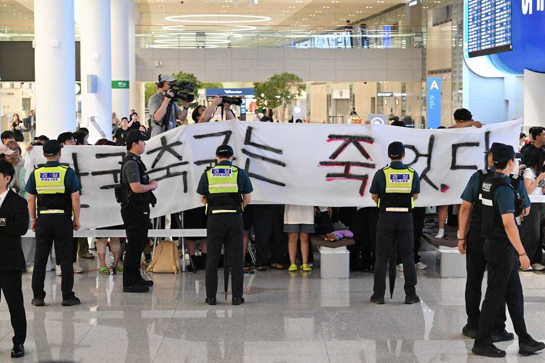 A group of people hold a banner reading "South Korea football is dead" as they wait for the arrival of South Korea's head coach Hong Myung-bo at Seoul-Incheon International Airport in Incheon on June 30. The best World Cup finish by an Asian nation was South Korea in 2002, when they placed fourth. Hong was part of South Korea's squad at the time.