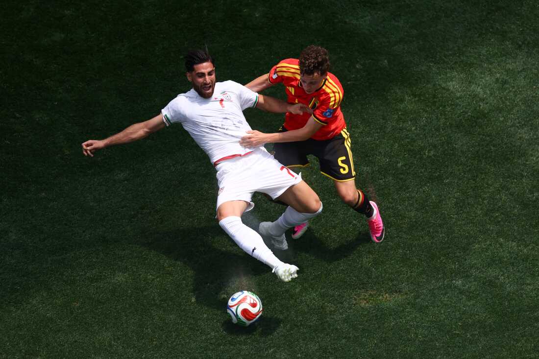 Iran's Alireza Jahanbakhsh is challenged by Belgium's Maxim De Cuyper during the 2026 World Cup match between Belgium and Iran on June 21 in Inglewood, Calif.